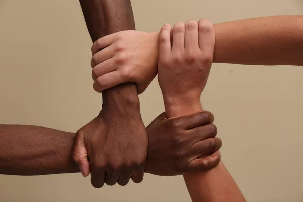 Men Joining Hands Together Beige Background Closeup — Stock Photo, Image