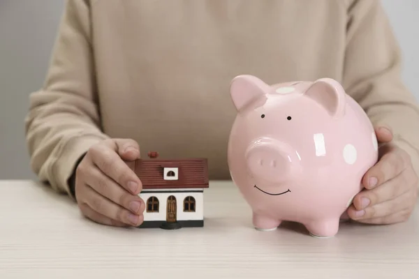 Man House Model Piggy Bank Wooden Table Closeup Saving Money — Foto de Stock