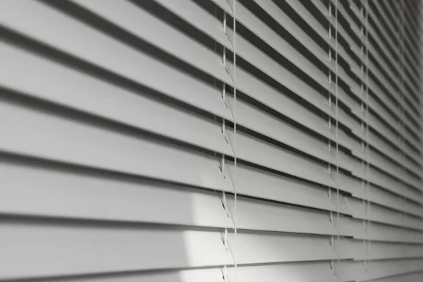 Closeup view of horizontal blinds on window indoors
