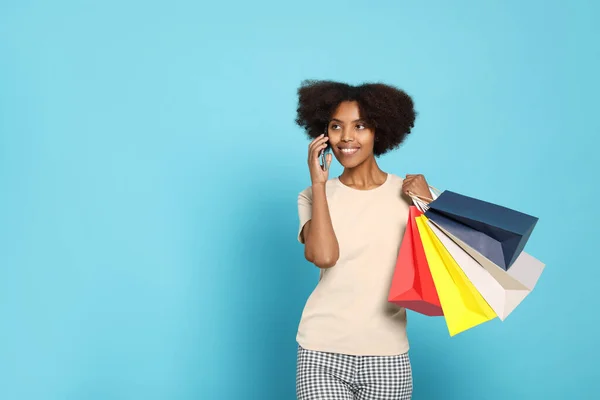 Happy African American Woman Shopping Bags Talking Smartphone Light Blue — Foto Stock