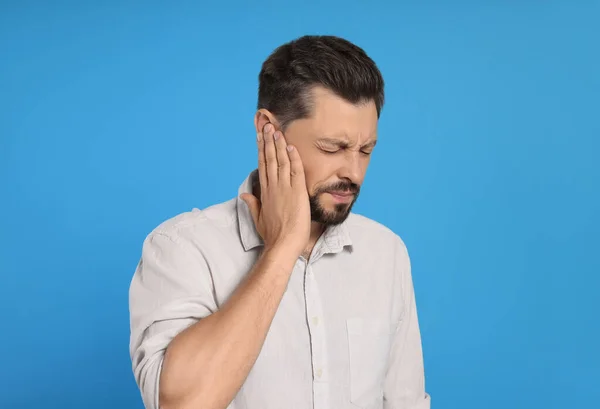 Man Suffering Ear Pain Light Blue Background — Fotografia de Stock