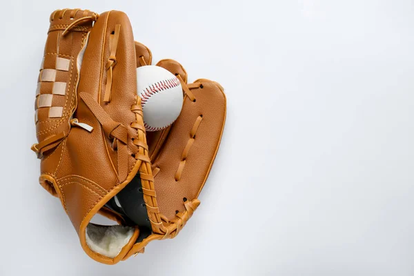 Catcher\'s mitt and baseball ball on white background, top view with space for text. Sports game
