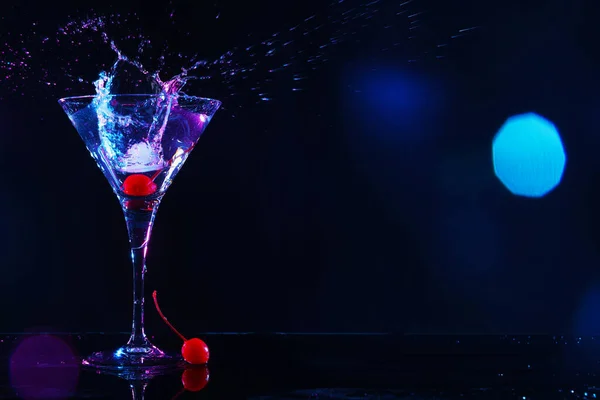 Martini Splashing Out Glass Cherry Black Background Space Text Bokeh — Zdjęcie stockowe