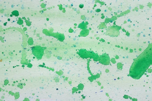 Abstract watercolor painting with green blots as background, top view