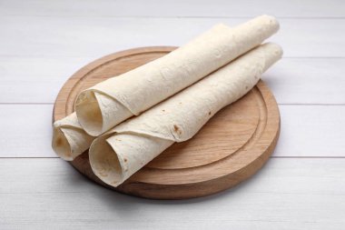 Delicious rolled Armenian lavash on white wooden table