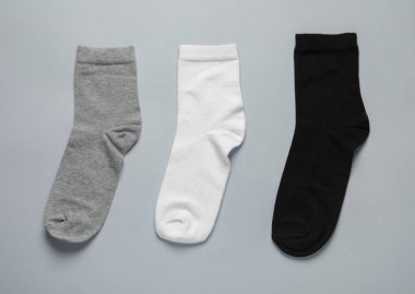 Different socks on light grey background, flat lay
