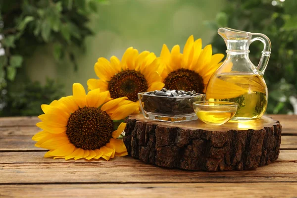 Composition with sunflower oil on wooden table against blurred background