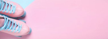 Pair of stylish quad roller skates on color background, flat lay. Space for text. Banner design