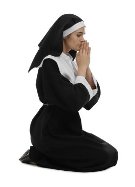 Nun with clasped hands praying to God on white background