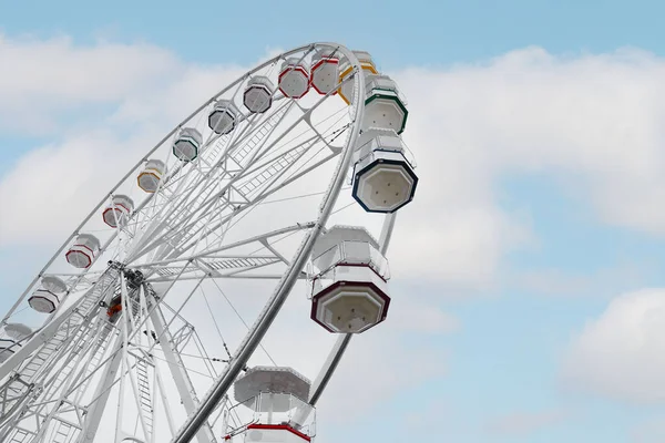 Large white observation wheel against sky, low angle view. Space for text