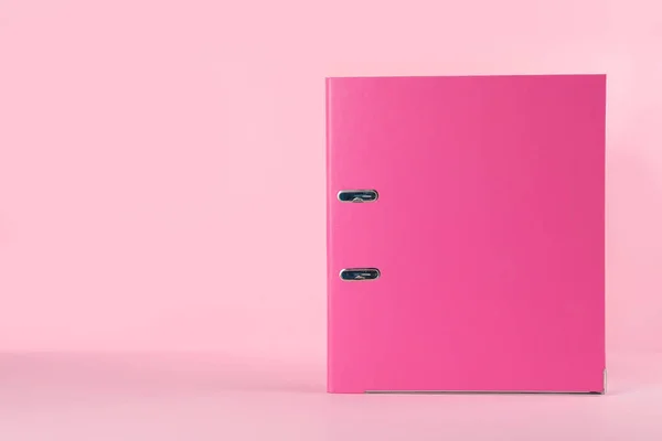 Office folder on pink background, space for text
