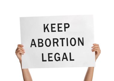 Woman holding placard with phrase Keep Abortion Legal on white background, closeup. Abortion protest