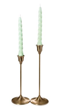 Vintage metal candlesticks with candles on white background