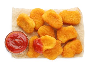 Tasty chicken nuggets with ketchup on white background, top view