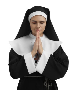 Nun with clasped hands praying to God on white background