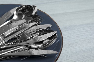 Different clean kitchenware on white wooden table, closeup. Space for text