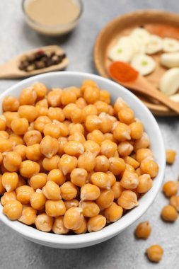 Delicious chickpeas on light grey table, closeup. Hummus ingredient