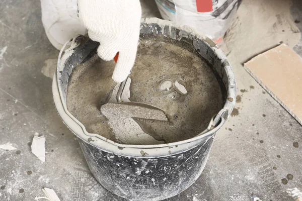 Worker Trowel Mixing Cement Bucket Indoors Closeup — Stockfoto