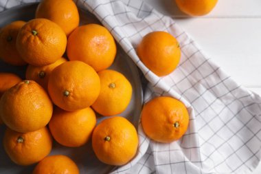 Many fresh ripe tangerines on white wooden table, flat lay