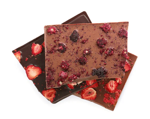Halves of chocolate bars with freeze dried berries on white background, top view