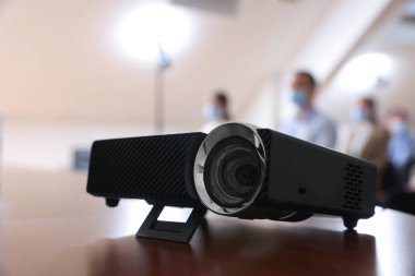 Modern video projector on table during conference