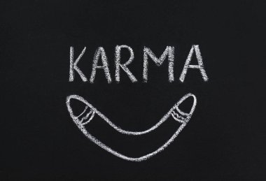 Drawn boomerang and word Karma written on blackboard clipart