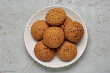 Delicious oatmeal cookies on light grey table, top view