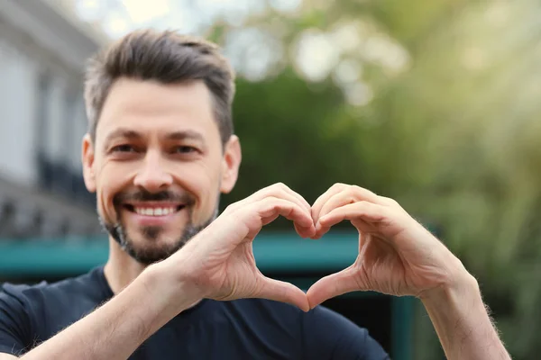 Happy Man Making Heart Hands Outdoors — Stockfoto