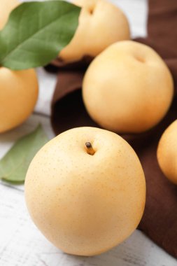 Delicious apple pears on white wooden table, closeup