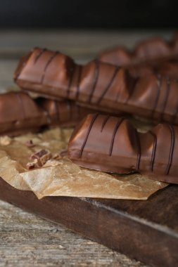 Tasty chocolate bars on wooden table, closeup