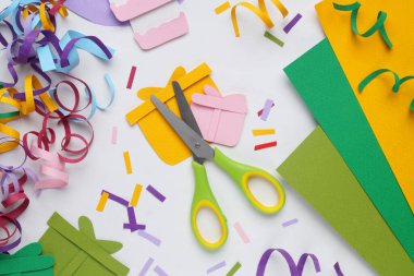 Flat lay composition with stationery, confetti and paper gift boxes on white background