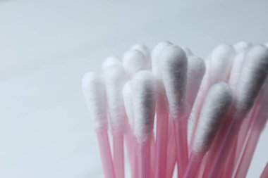 Many cotton buds on white background, closeup. Space for text