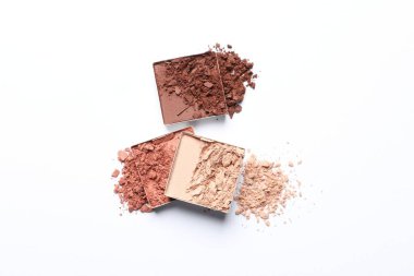 Different crushed eye shadows on white background, top view