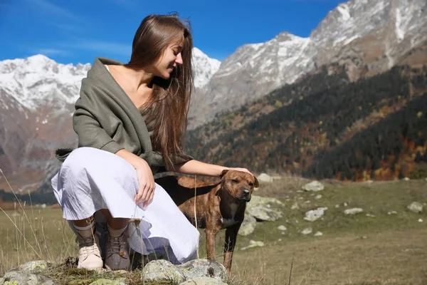 Beautiful Young Woman Stroking Adorable Dog Mountains Sunny Day — Fotografia de Stock