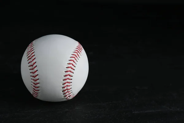 Baseball ball on black background, space for text. Sports game
