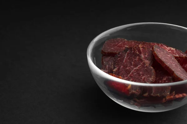 Bowl Pieces Delicious Beef Jerky Black Table Closeup Space Text — Stockfoto