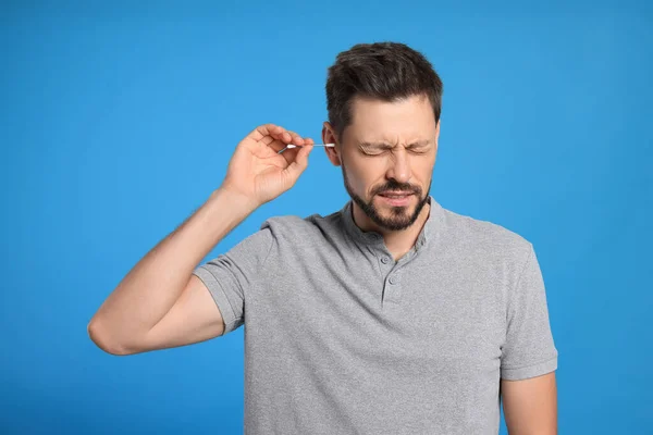 Man Cleaning Ears Suffering Pain Light Blue Background — Fotografia de Stock