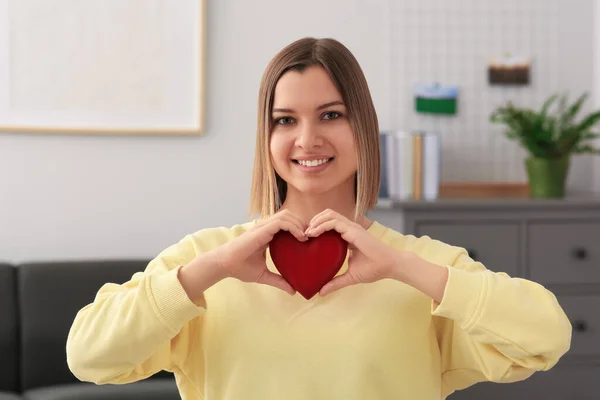 Young Woman Holding Red Heart Indoors Volunteer Concept — Stockfoto