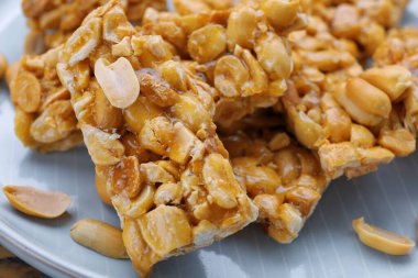 Delicious peanut kozinaki bars on plate, closeup