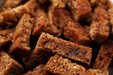 Delicious crispy rusks as background, closeup view