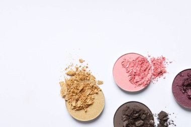 Different crushed eye shadows on white background, flat lay. Space for text