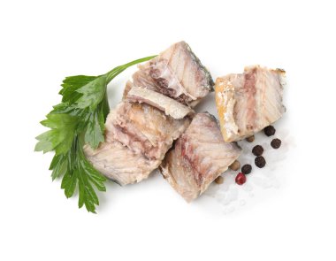 Delicious canned mackerel chunks with parsley and spices on white background, top view