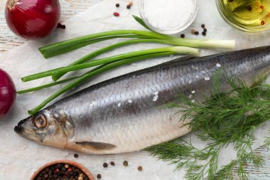 Delicious salted herring and ingredients on wooden table, flat lay