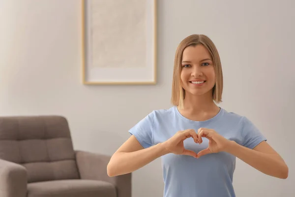 Young Woman Making Heart Hands Indoors Space Text Volunteer Concept — Stockfoto