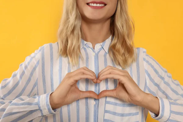 Happy Volunteer Making Heart Her Hands Orange Background Closeup — Stockfoto