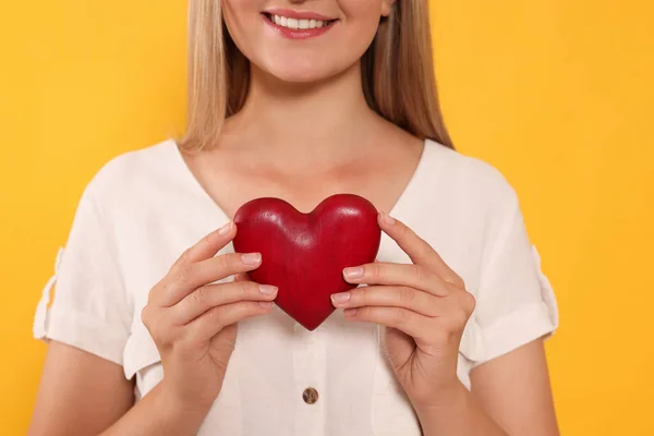 Happy Volunteer Holding Red Heart Hands Orange Background Closeup — Stockfoto
