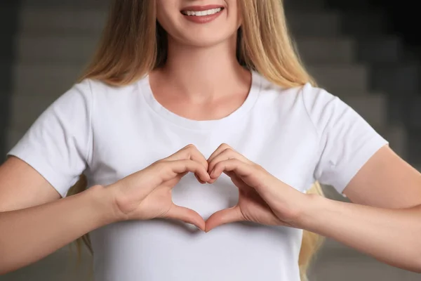 Young Woman Making Heart Hands Indoors Closeup Volunteer Concept — Stockfoto