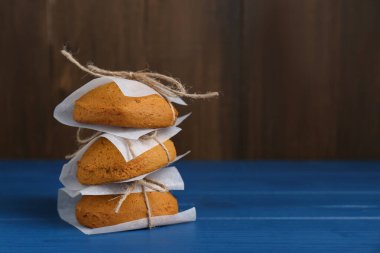 Stack of tasty oatmeal cookies on blue wooden table. Space for text