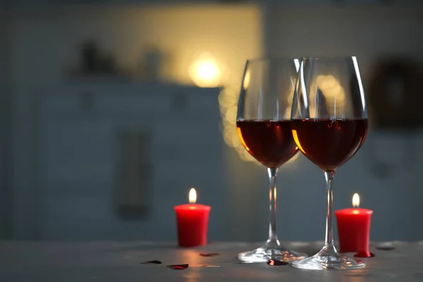 Glasses Red Wine Burning Candles Grey Table Blurred Lights Space — Stock Fotó