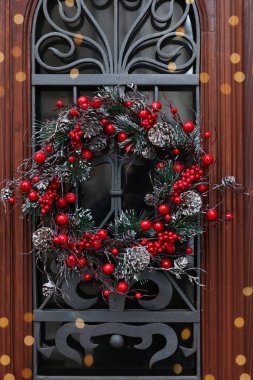 Beautiful Christmas wreath hanging on wooden door